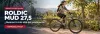 Mujer recorriendo un parque en bicicleta MTB Roldic aro 27.5 gris
