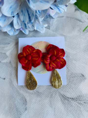 Flor roja con colgante dorado
