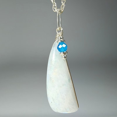 Colgante De Piedra Luna Blanca Con Destello Azul Y Apatita Azul en Cabuchón Triangular de 31 mm