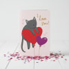 Tarjeta de San Valentin con diseño de gatito sobre globos 