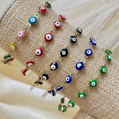 Pulsera protección con ojos turcos nazar en acero dorado / unidad