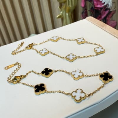 Pulsera trébol 4 hojas blanco negro acero dorado / unidad