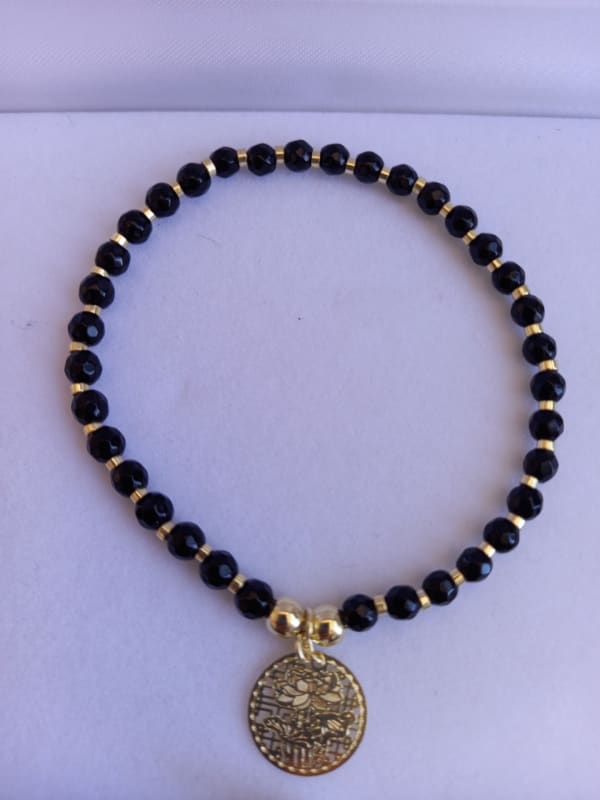 PULSERA PIEDRA NEGRA ORO AMARILLO